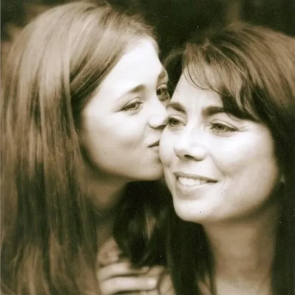 A black and white photo of a woman kissing her mother while overcoming Glanzmann's Thrombasthenia.