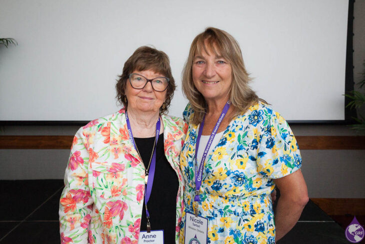 Two women standing next to each other at a conference discussing Glanzmann's thrombasthenia.