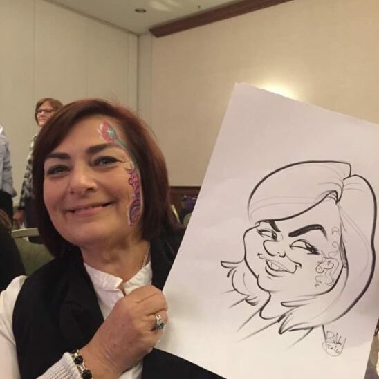 A woman with glanzmann's thrombasthenia holding up a drawing of a caricature.